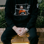 Moon Soldier Vigilante black sweatshirt with vigilante character graphic in a fragmented frame, worn by model in a casual setting.